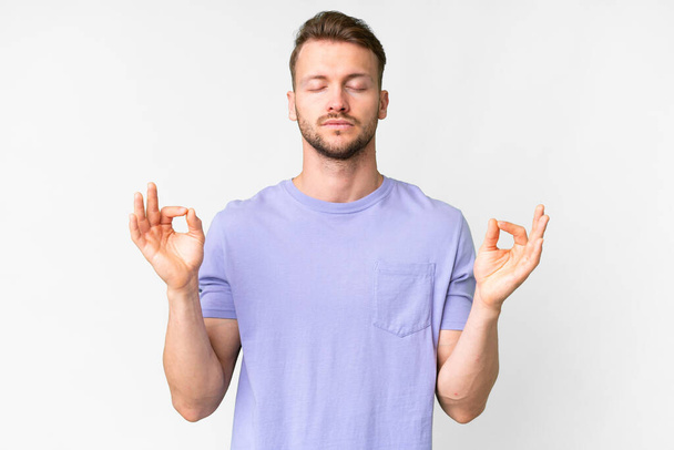 Young handsome caucasian man over isolated white background in zen pose - Foto, imagen