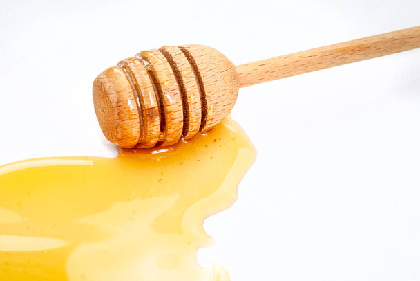 Honey with honey dipper isolated on white - Photo, Image