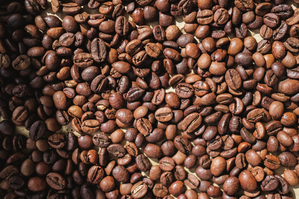 Coffee beans on brown paper background, can be used as a background - Photo, Image