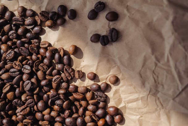 grains de café sur fond de papier brun, peut être utilisé comme fond - Photo, image