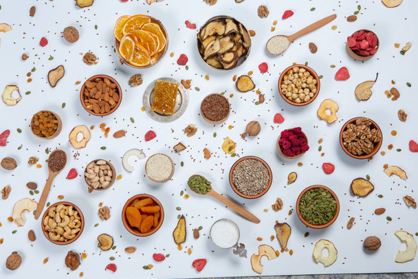 Healthy vegetarian food concept. Assortment of dried fruits, nuts and seeds on white background. Top view. - Fotoğraf, Görsel