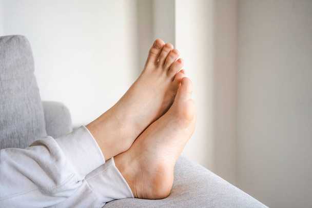 Close up of boy foot lying on floor at home - Фото, зображення