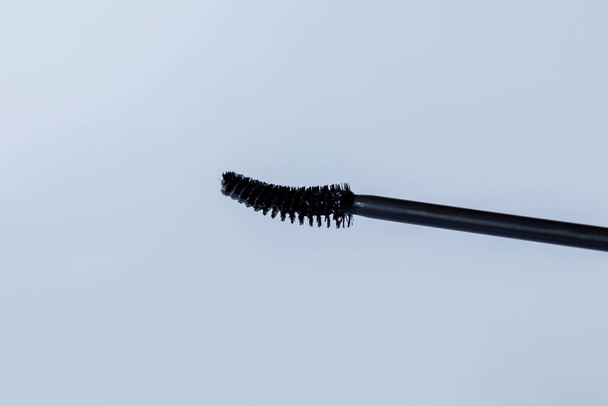 Black Mascara brush on white background, close-up. - Foto, immagini