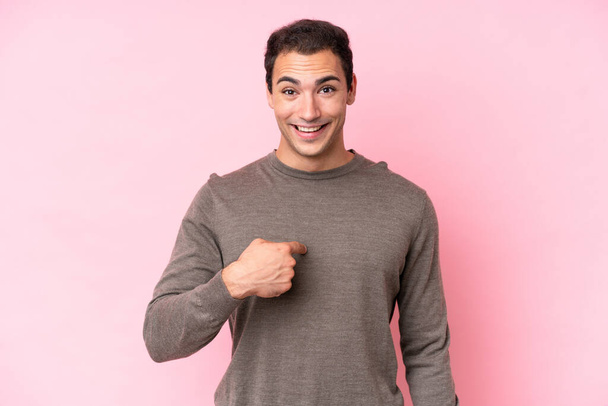 Young caucasian man isolated on pink background with surprise facial expression - Fotó, kép