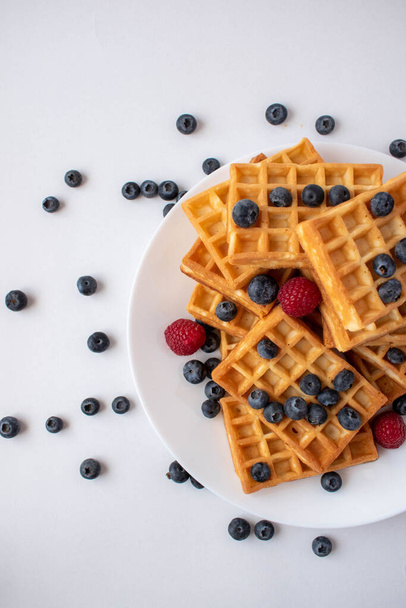 Traditional Belgian waffles with blueberries and raspberries for breakfast - Photo, Image
