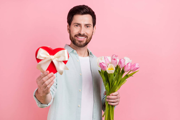Photo portrait of attractive young man giftbox bouquet tulips valentine day dressed stylish blue outfit isolated on pink color background. - Фото, изображение