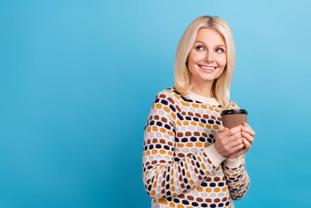 Portrait of positive cheerful lady wear trendy clothes hold tasty tea look empty space interesting offer isolated on blue color background. - Foto, imagen