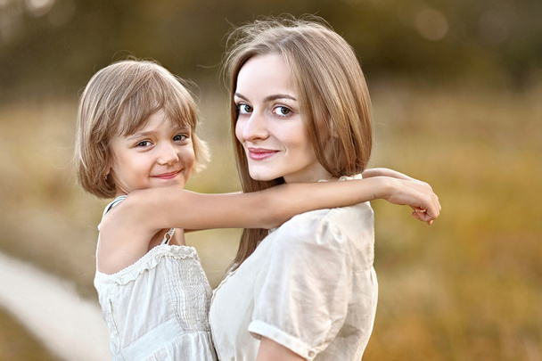 portrait of mother and daughter in nature - Photo, image