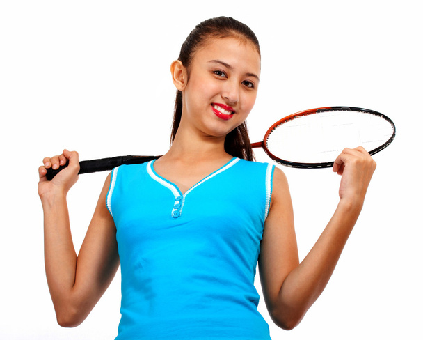 sportos lány holding tollaslabda ütő - Fotó, kép
