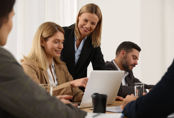 Businesswoman having meeting with her employees in office - Photo, image