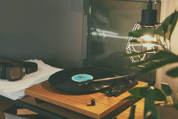 Stylish turntable with vinyl record on table indoors - Фото, зображення