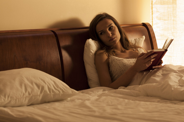 Lonely woman in bed - 写真・画像