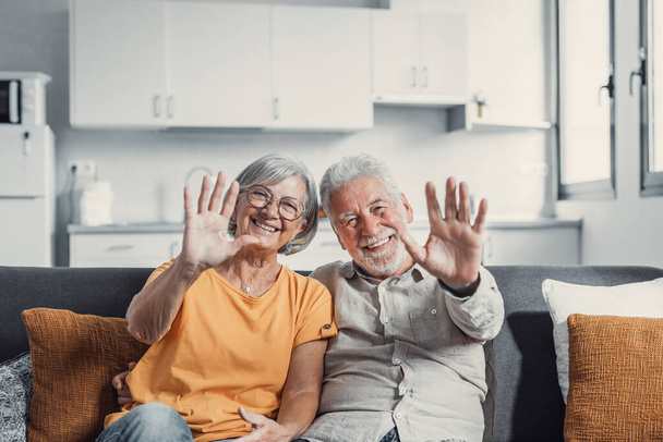 60 Jahre Paar, ältere Eltern kommunizieren mit erwachsenen Kindern mit modernen Technologien macht Videoanruf, winken Hände Geste des Hallo oder Abschiedszeichen, ältere Generation und Internet-Konzept - Foto, Bild