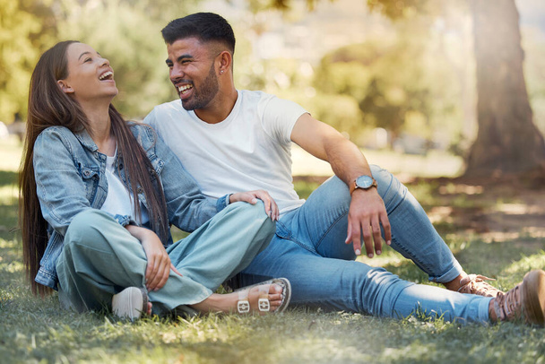 Couple are happy outdoor, laughing and relax together, love and care with trust in relationship and commitment. Happiness, support and freedom with man and woman in park with romance and bonding. - 写真・画像