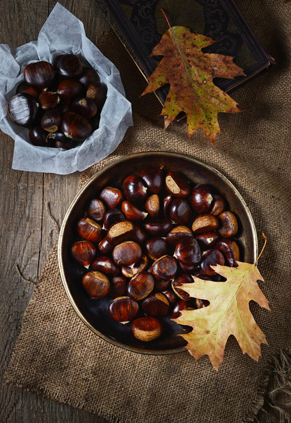 Roasted chestnuts in pan on rustic background - Photo, Image