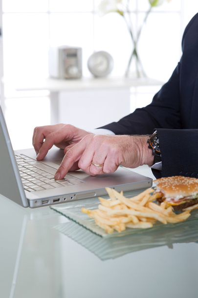Manager working and eating unhealthy food - 写真・画像