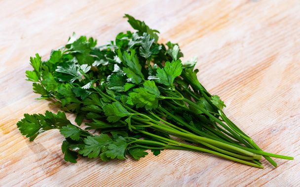 Green parsley on wooden table closeup. High quality photo - Photo, image