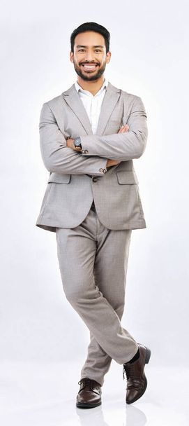 Portrait, professional and a business man on a gray background, standing arms crossed in studio. Corporate, smile and trust with a happy male employee looking confident in the success of his company. - Foto, Imagen