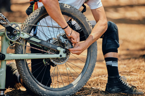 Maintenance, race and a man with a bicycle in nature for cycling, construction and building a bike. Fitness, sports and a biker with transportation. fixing a gear and wheels during cardio in a park. - Photo, Image