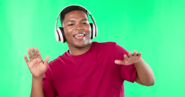 Headphones, dance and black man on green screen studio, music and singing online audio. Dancing, freedom and happy guy with podcast, radio or wellness playlist while having fun on mockup background. - Metraje, vídeo