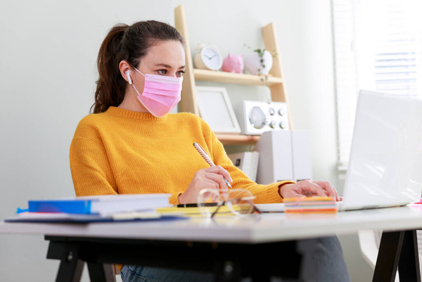 Young woman working from home after coronavirus pandemic - Фото, изображение