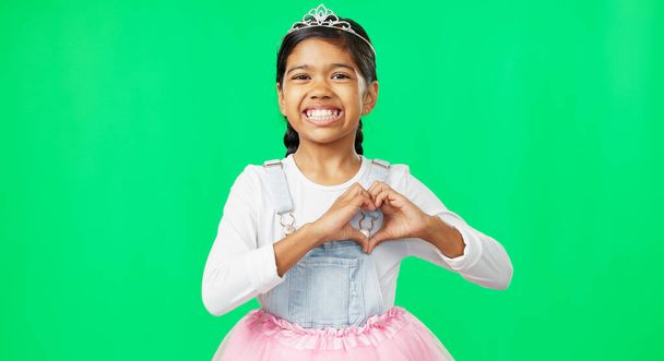Heart, green screen and love hand gesture by child excited, smile and excited isolated in studio background. Young, care and support sign by girl or kid in princess costume or tutu showing symbol. - Foto, Imagem
