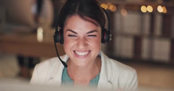 Business, night and woman waving, video call and meeting in workplace, smile and help. Female employee, happy agent and consultant with headphones, greeting and talking in office and webinar. - Felvétel, videó