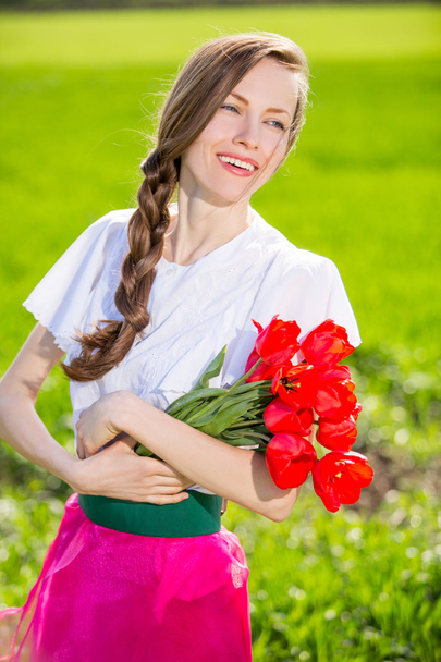 Beauty Woman with Spring Flower bouquet - Фото, изображение