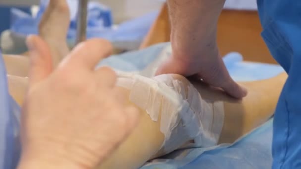 Крупним планом хірург, який вивчає вени на нозі пацієнтів після операції, варикозне розширення вен на руках хірургів у стерильних рукавичках
. - Кадри, відео