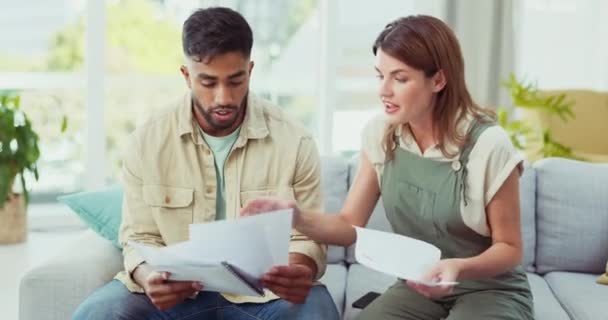 Interracial couple, tax and finance paper in home for reading, insurance and accounting together. Indian man, caucasian woman and documents for financial compliance, budget or wealth planning on sofa. - Filmmaterial, Video