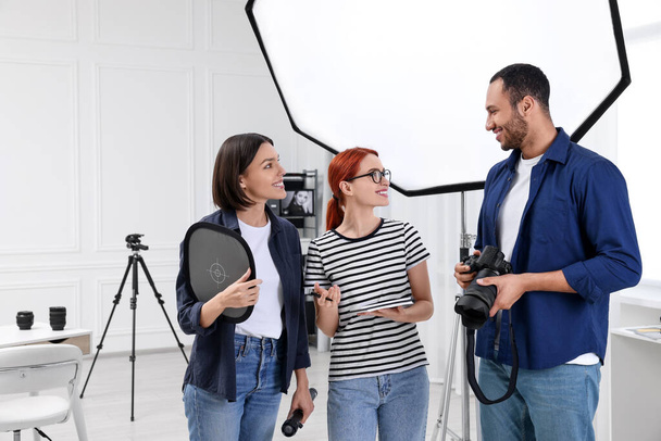 Young professional photographers working in modern photo studio, space for text - Fotó, kép