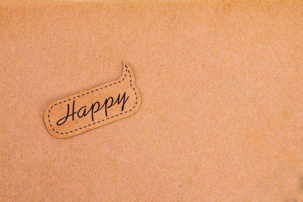 happy tag on brown paper background - 写真・画像