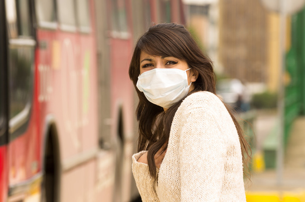 young girl walking wearing a mask in the city street concept of  pollution - Photo, image