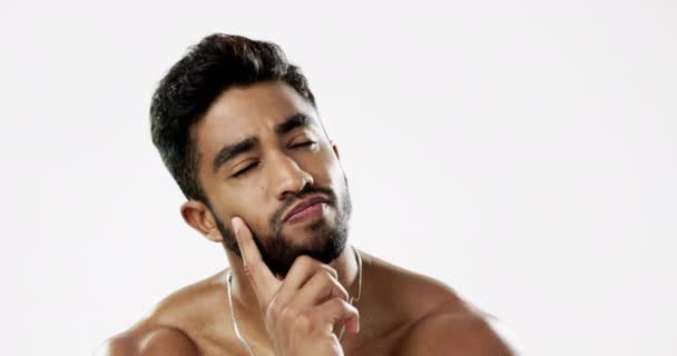 Thinking, confused and face of man in studio for wellness, skincare and hygiene on white background. Doubt, portrait and Indian male model with unsure emoji contemplating beauty cosmetic or body care. - Metraje, vídeo