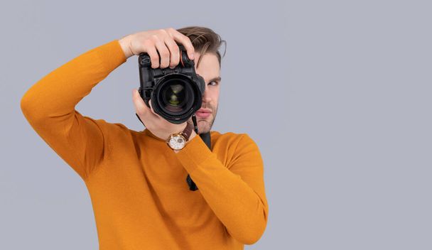 man photographer with photo camera, copy space. photo of man photographer with camera. man photographer with camera isolated on grey background. man photographer with camera in studio. - Photo, Image