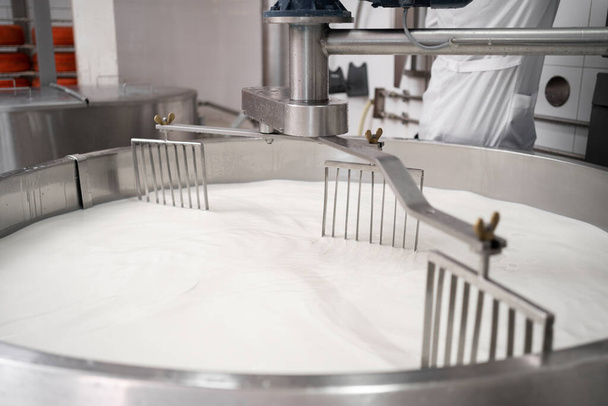 Cooking milk in a stainless steel tank for cheese production. Cheese factory concept. Copy space - Photo, Image