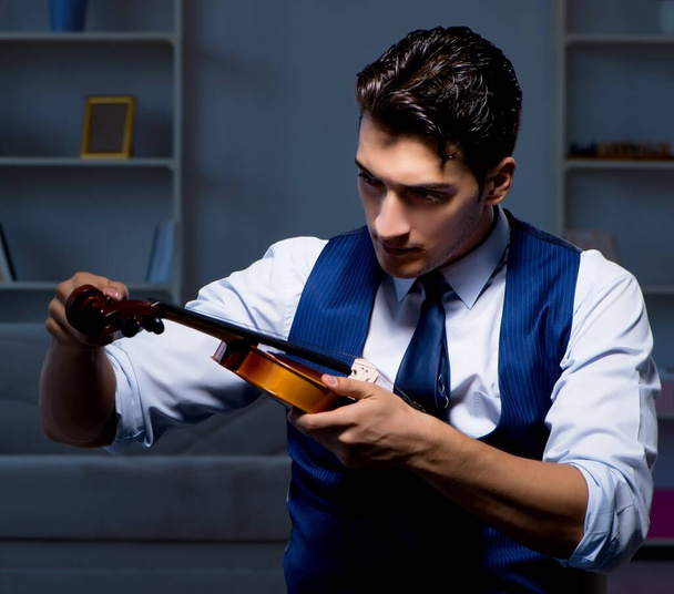 The young musician man practicing playing violin at home - Photo, Image
