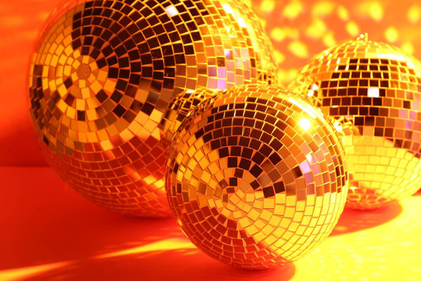 Many shiny disco balls indoors, toned in orange - Fotó, kép