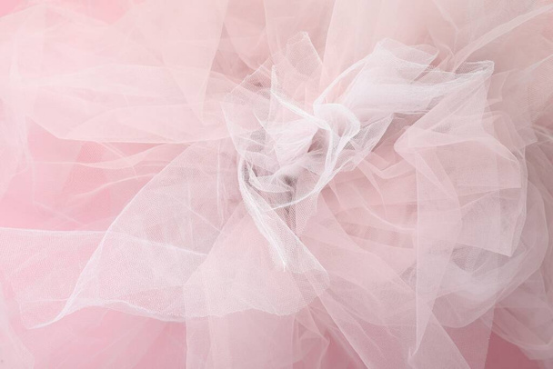 Beautiful tulle fabric on pink background, closeup - Fotó, kép