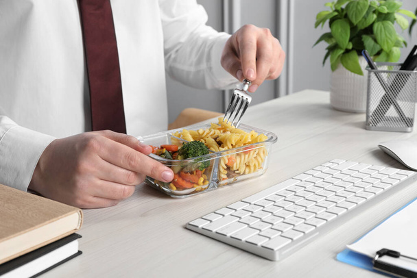 Office employee having business lunch at workplace, closeup - Foto, Bild