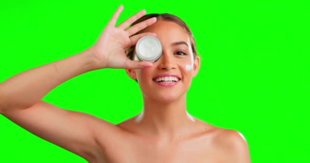 Face cream, skincare and woman in studio with skin, product and beauty routine on green screen background. Portrait, sunscreen and girl relax, smile and happy with dermatology, cosmetics and facial. - Video, Çekim