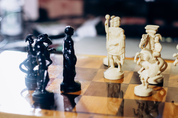 Chess pieces are on board. Queen and king in chess are in difficult situation - Fotografie, Obrázek