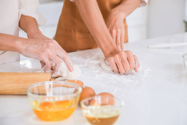 Woman kneading dough on the table. - Photo, Image
