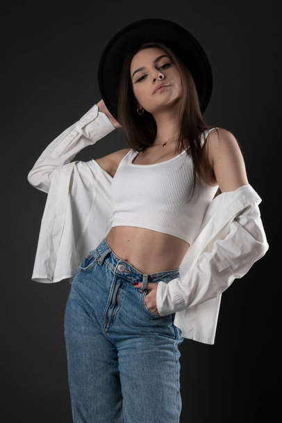 Young and beautiful teenage girl in denim jeans  - Фото, зображення