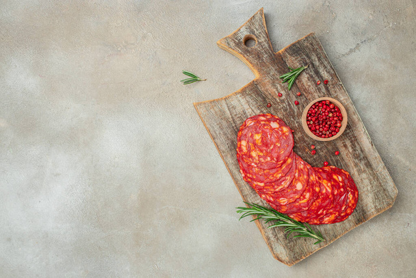 Spanish traditional chorizo sausage on a wooden board. banner, menu, recipe place for text, top view. - Foto, immagini