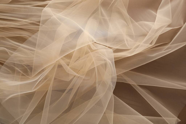 Beautiful tulle fabric on brown background, top view - Fotografie, Obrázek
