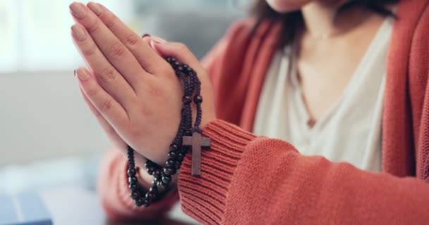 Christian woman, rosary and hands praying in home of spiritual faith, holy gospel and worship God. Closeup female, prayer beads and cross for religion, mercy and praise lord of jesus, heaven or peace. - Footage, Video