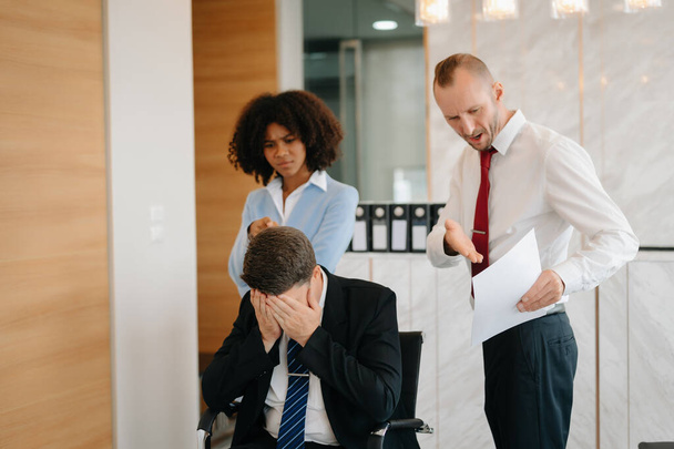 Team thinking of problem solution at modern office meeting, sad diverse business people group shocked by bad news, upset colleagues in panic after company bankruptcy concept - Фото, зображення