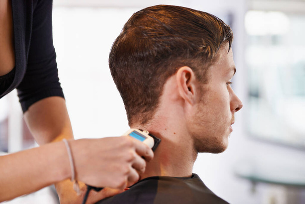 Hes getting a close shave. a young man having his hair styled at a hair salon - Zdjęcie, obraz