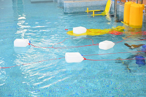 galón de plástico blanco con el uso de la cuerda roja para ayudar a la gente a caer en el agua, boya lanzada salvamento ahogamiento persona - Foto, imagen